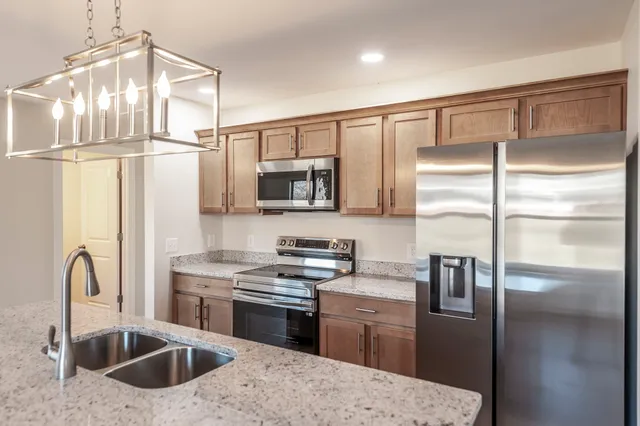 a kitchen with a refrigerator sink and stainless steel appliances