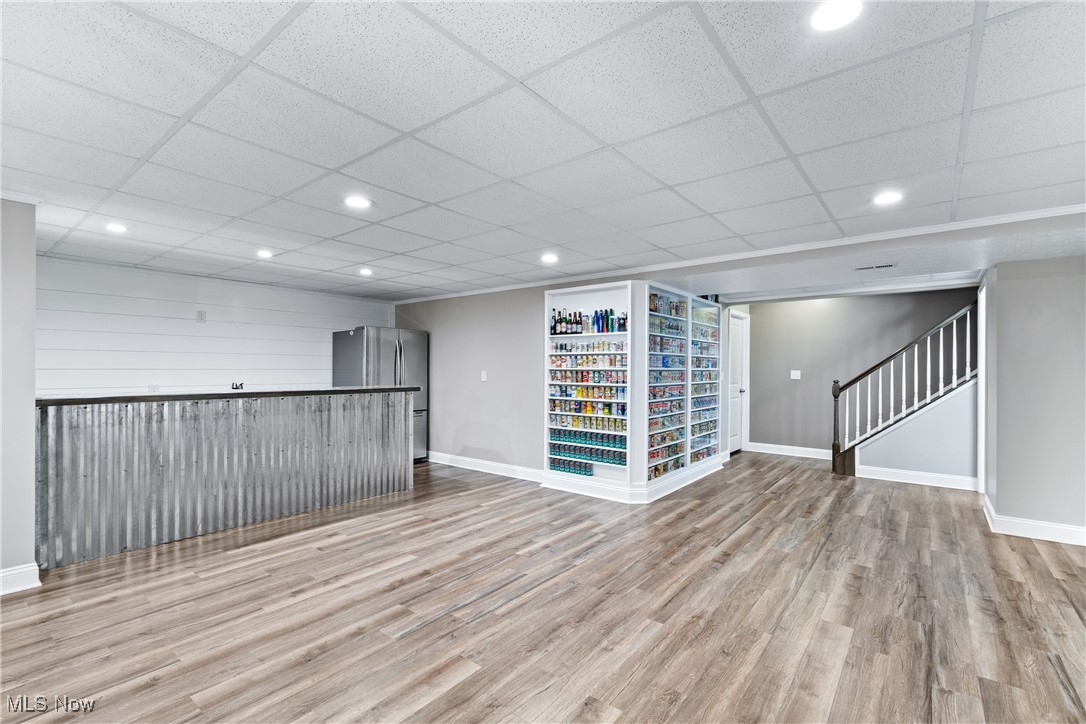 191 Ry Road Wadsworth, OH 44281 - Photo 23 of 34 Empty room with light wood finished floors, recessed lighting, stairs, and a paneled ceiling