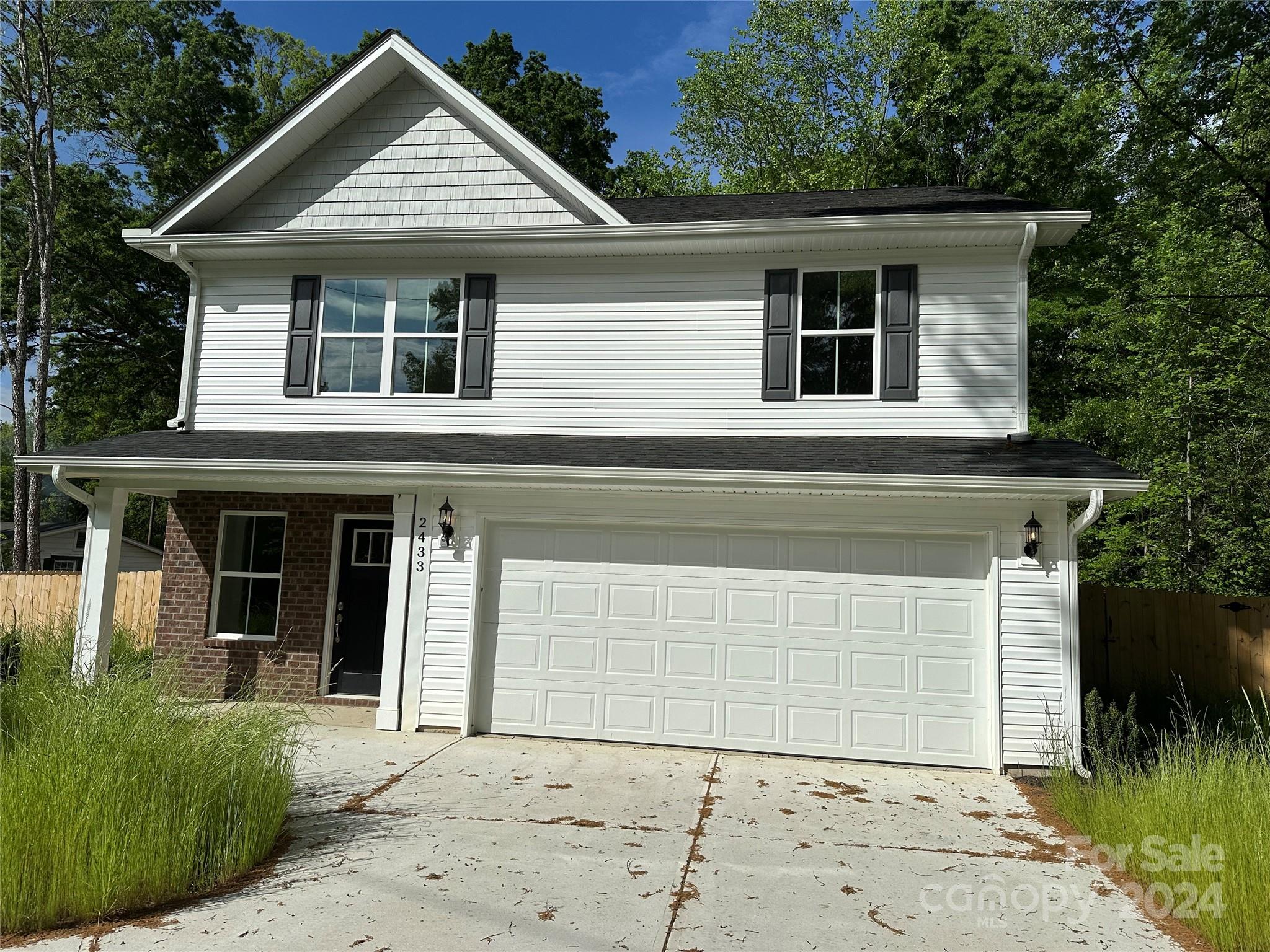 2433 Craig Farm Road Lancaster, SC 29720 - Photo 7 of 36 a front view of a house with a yard and garage