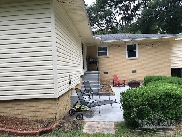 a view of a patio with table and chairs and potted plants