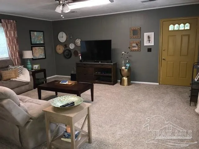 a living room with furniture and a flat screen tv