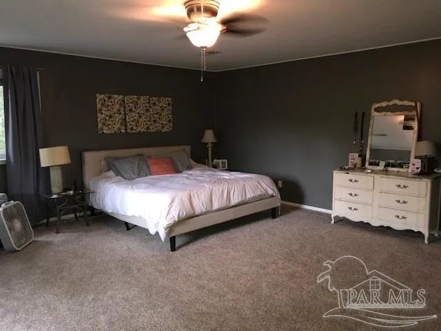 a bedroom with a bed and dresser