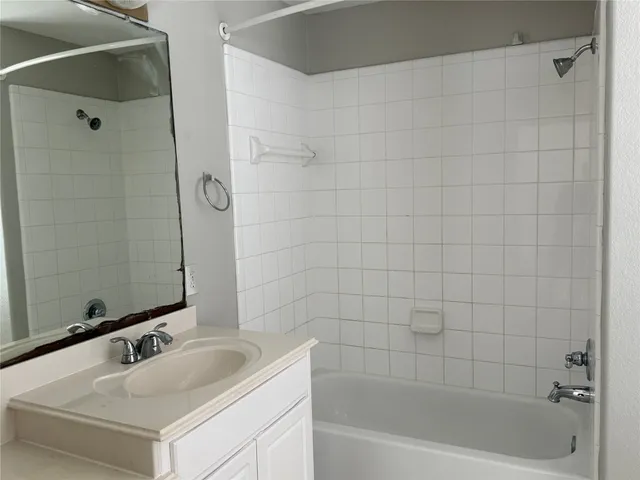 a bathroom with a bathtub and a sink