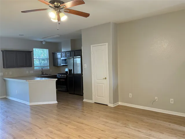 a kitchen with a refrigerator and a sink