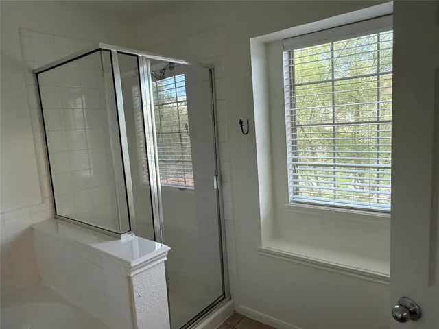 a bathroom with a shower and a sink