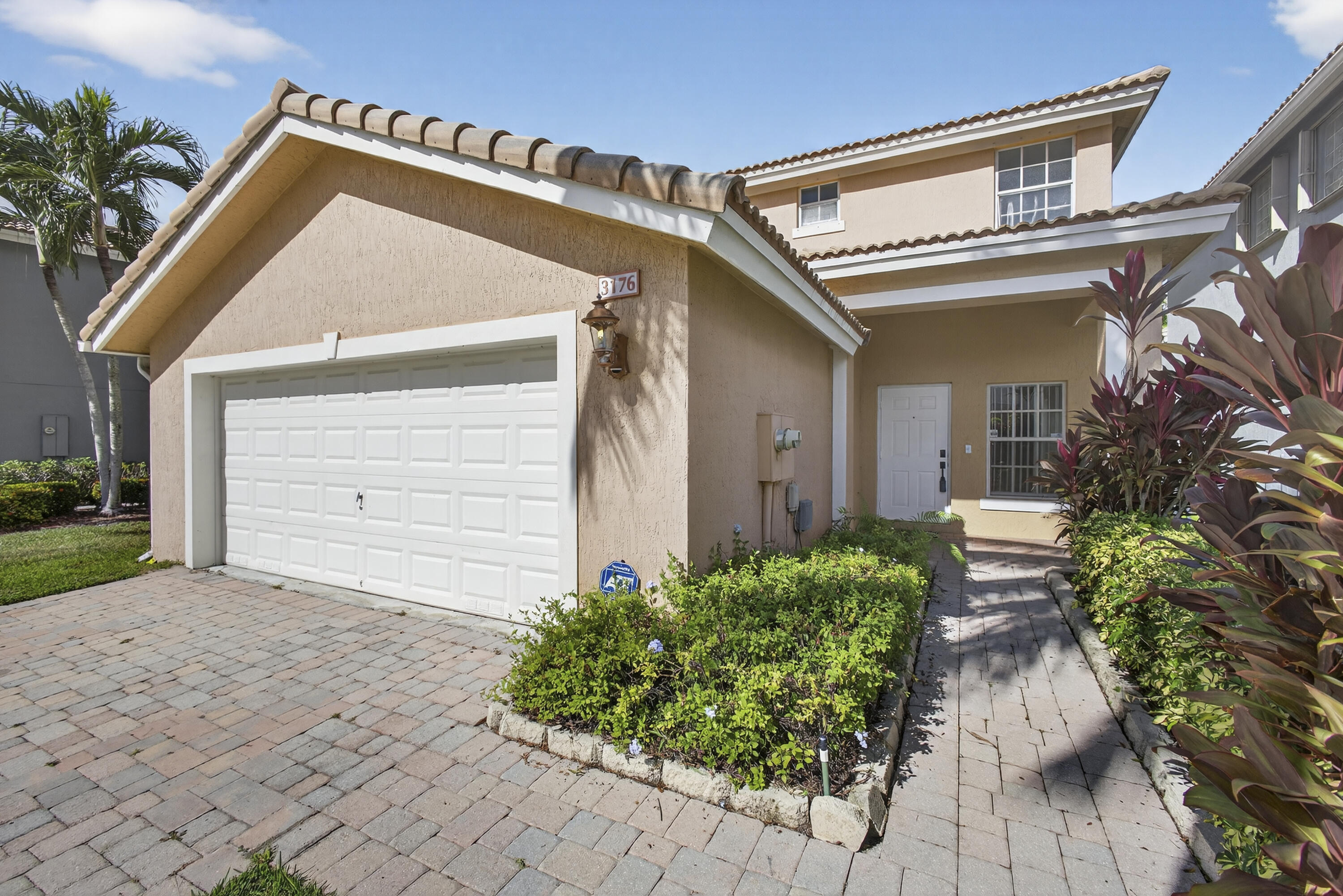 a front view of a house with garden