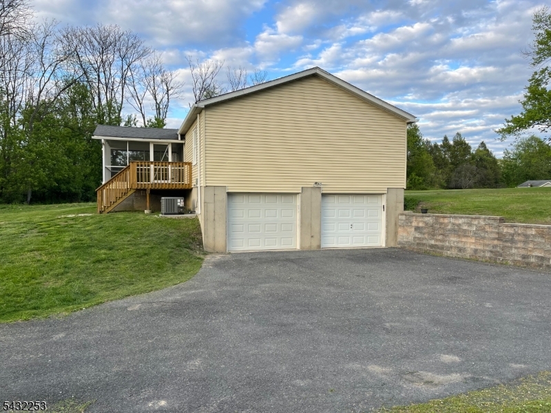 31 Countryside Road Columbia, NJ 07832 - Photo 27 of 31 a view of a house with a yard and garage
