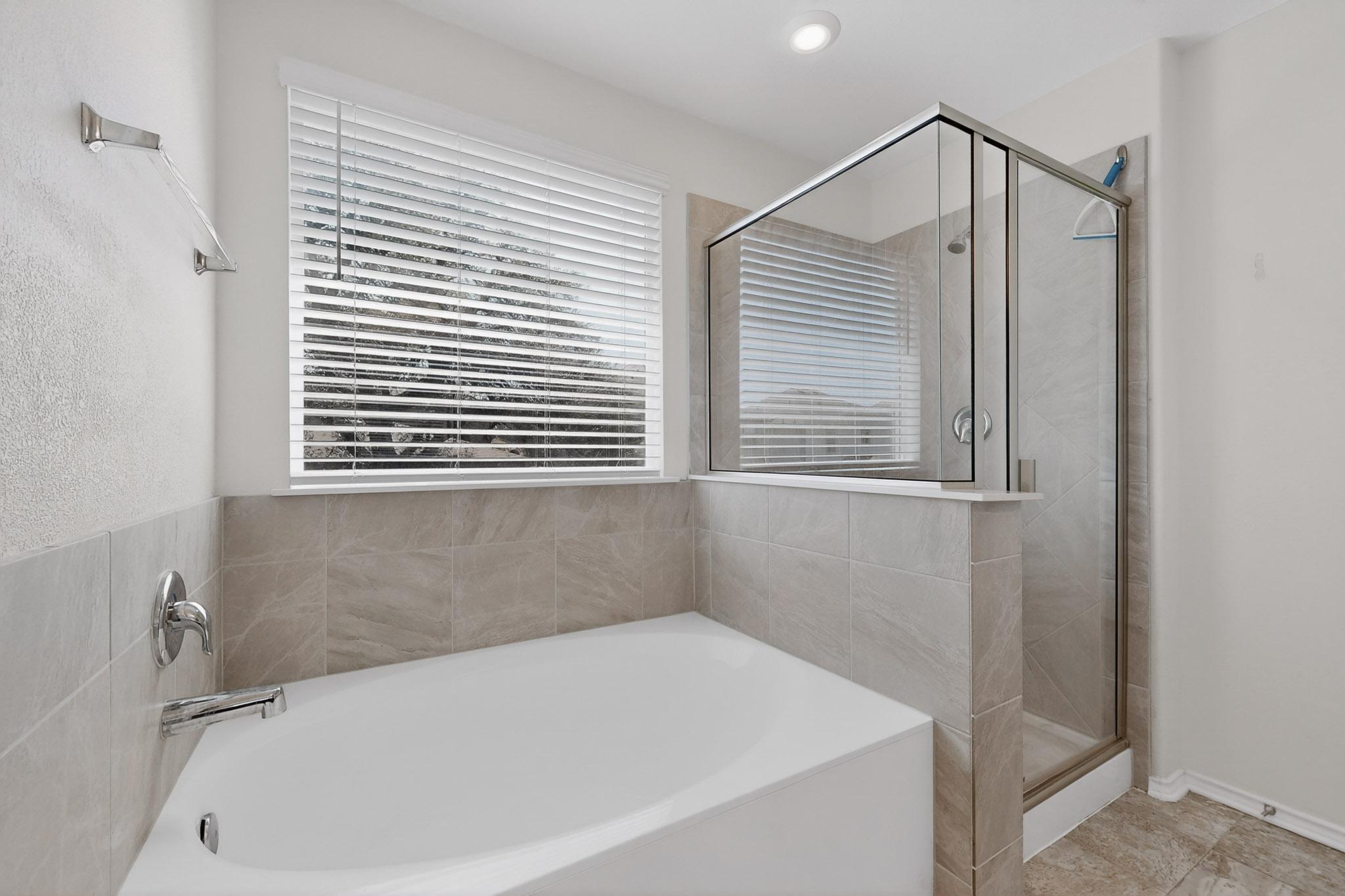 712 Madalin Rue Court Leander, TX 78641 - Photo 13 of 28 Full bath featuring a bath and a shower stall
