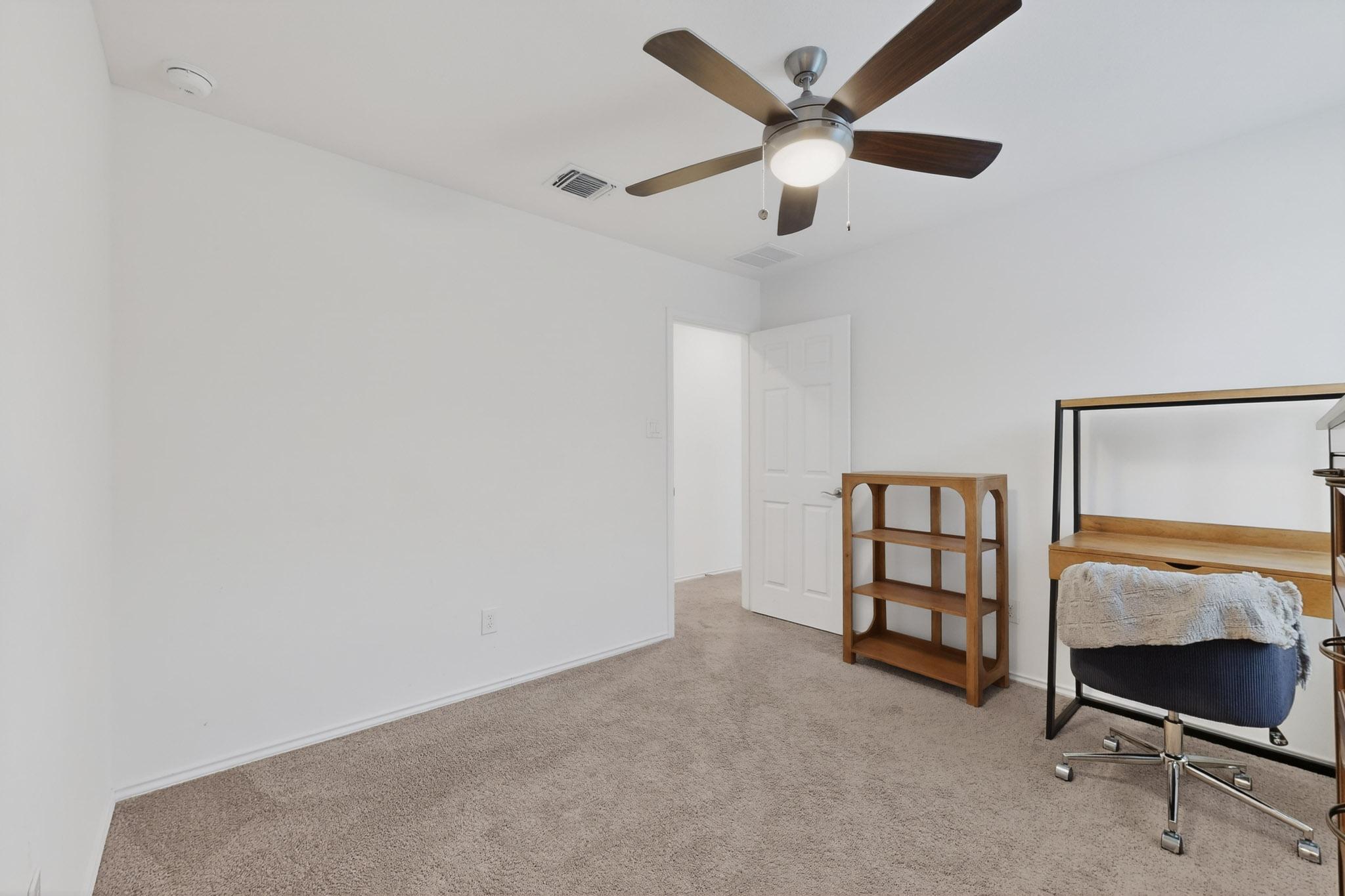 712 Madalin Rue Court Leander, TX 78641 - Photo 18 of 28 Office with light colored carpet and ceiling fan