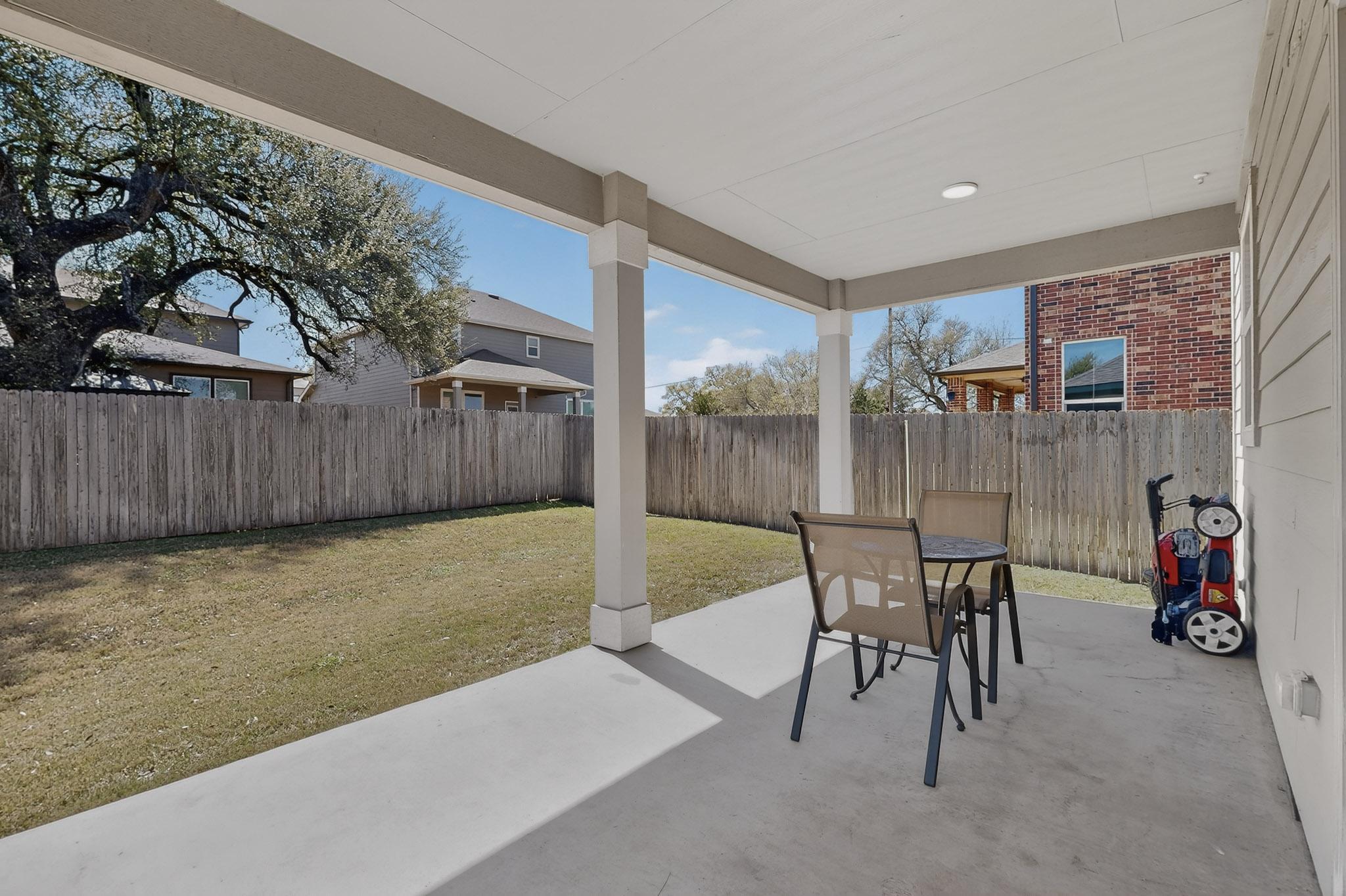 712 Madalin Rue Court Leander, TX 78641 - Photo 22 of 28 Fenced backyard with a patio area and outdoor dining space