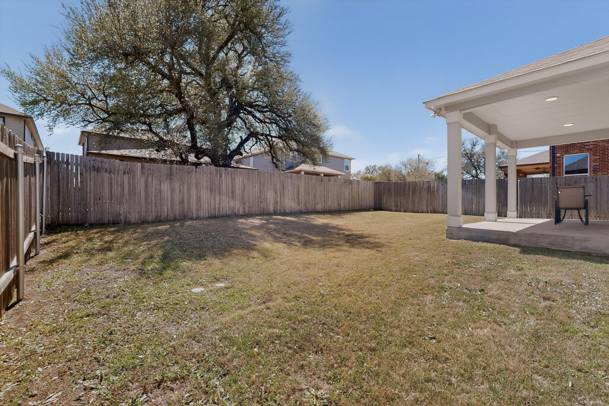 712 Madalin Rue Court Leander, TX 78641 - Photo 24 of 28 Fenced backyard with a patio