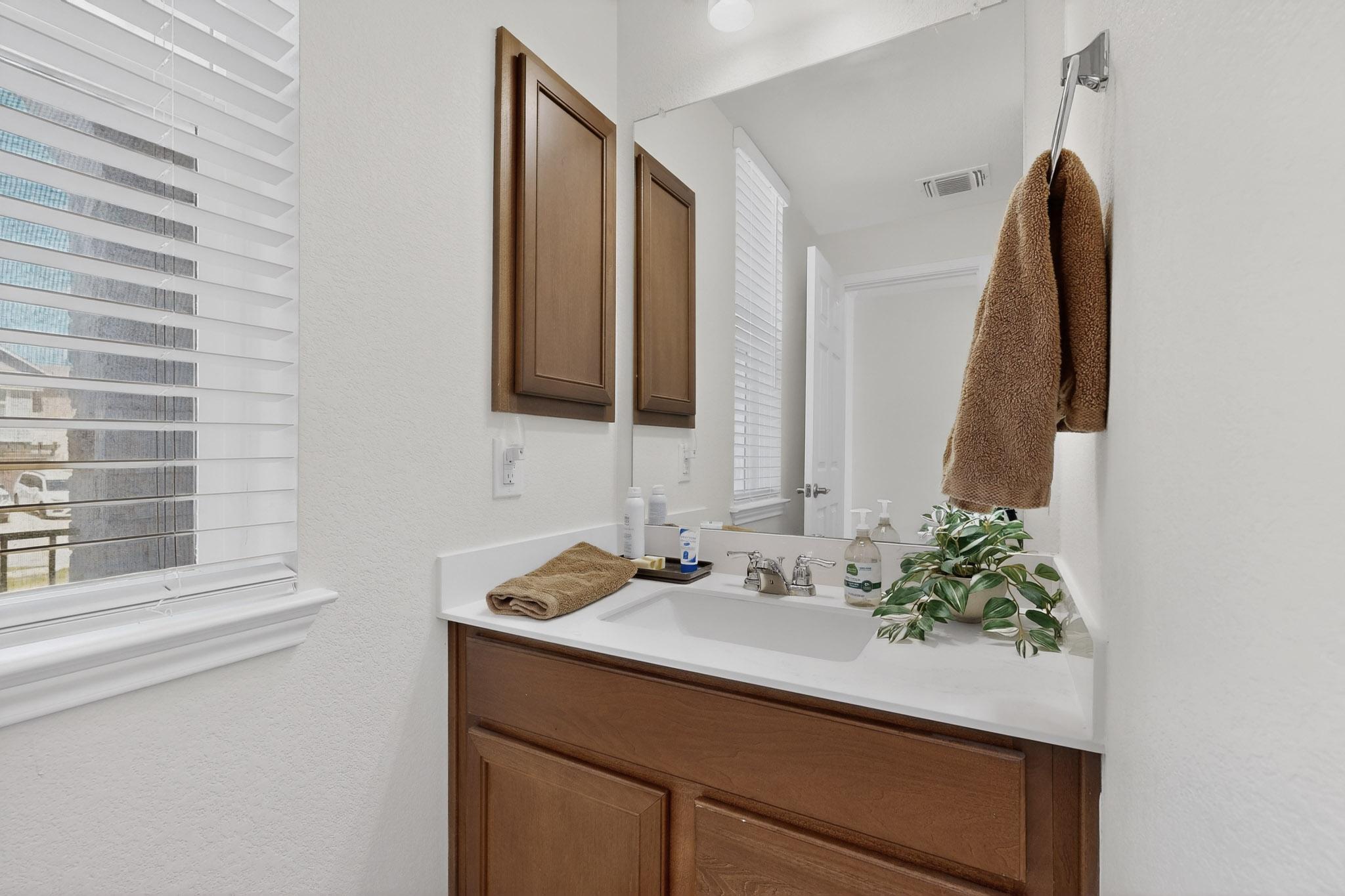 712 Madalin Rue Court Leander, TX 78641 - Photo 10 of 28 Bathroom featuring vanity and a textured wall