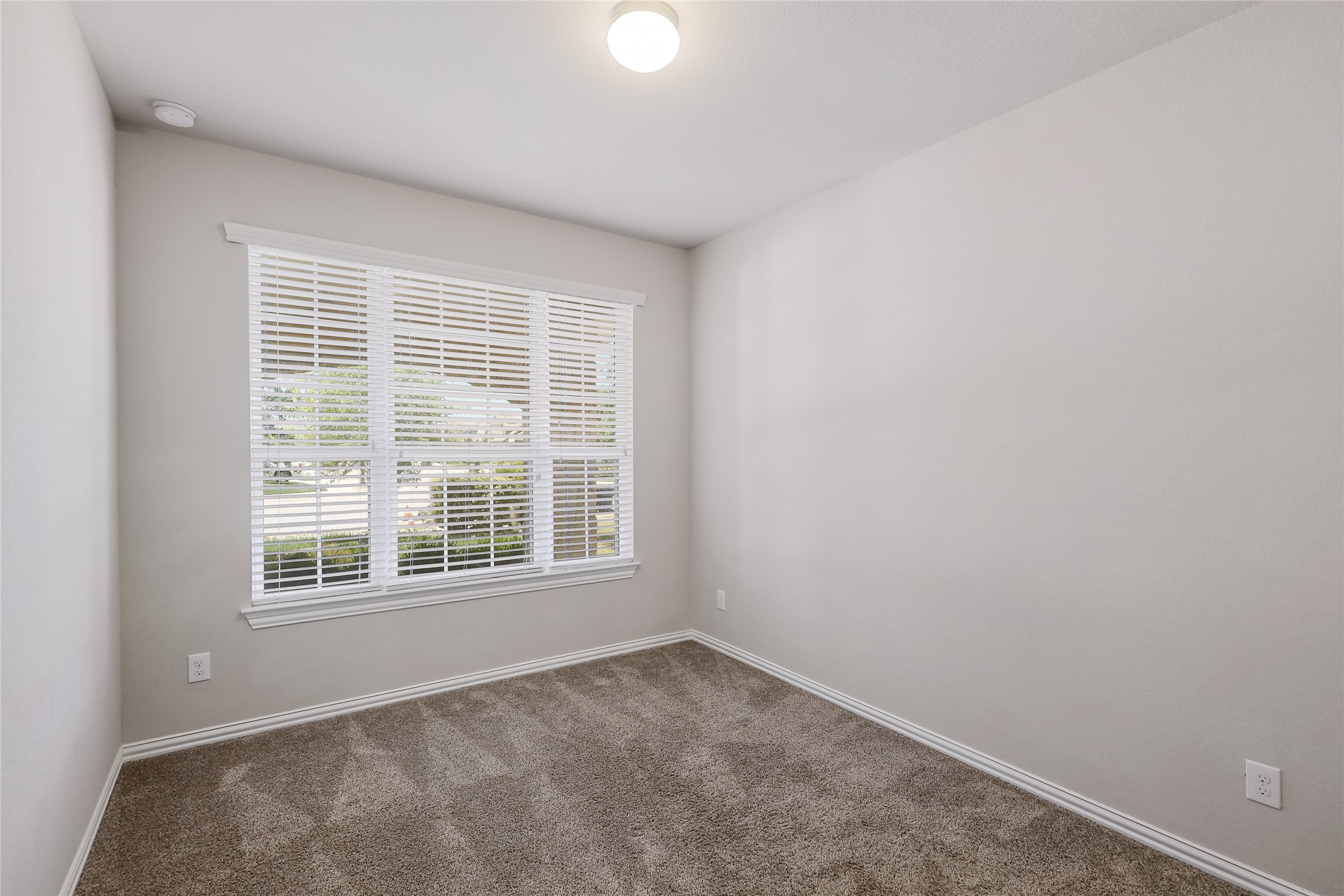 205 Penna Lane Georgetown, TX 78628 - Photo 20 of 32 A well-lit secondary room offers ample natural light and plush carpeting for comfort.