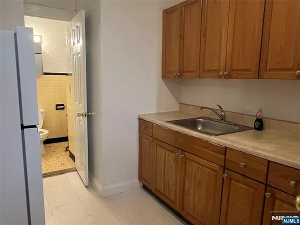 a kitchen with a sink and a refrigerator