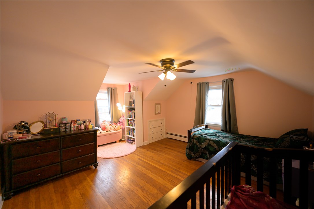 220 Shawmut Avenue Central Falls, RI 02863 - Photo 16 of 25 Bedroom #3, gleaming hardwood floors, two windows that let the light in. This bedroom is on the 2nd level.