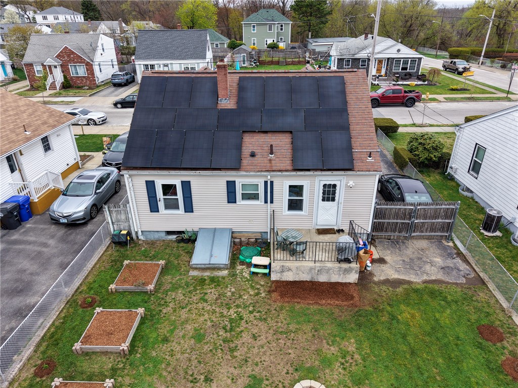 220 Shawmut Avenue Central Falls, RI 02863 - Photo 24 of 25 A backyard that offers the best of both worlds, an expansive green lawn for outdoor activities and a curated area for planting beds. This home also features a bulkhead for easy access to basement.