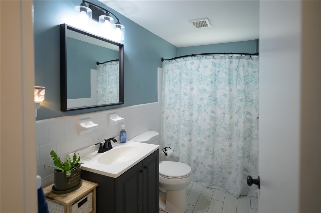 220 Shawmut Avenue Central Falls, RI 02863 - Photo 10 of 25 This main bathroom boasts a minimalist, modern appeal that makes great use of the space. It's a bright airy room for today's lifestyle.