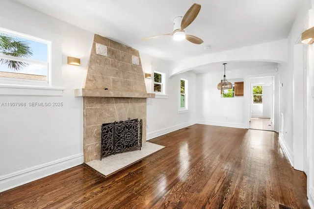 a living room with wooden floors and a fireplace