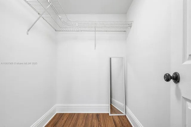 a view of a room with wooden floor