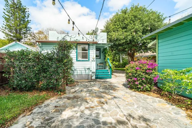 a view of a house with a yard and garden