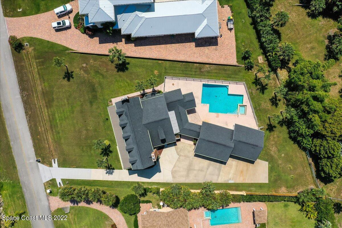 2420 Rocky Point Road Malabar, FL 32950 - Photo 13 of 97 an aerial view of a house with a garden and trees