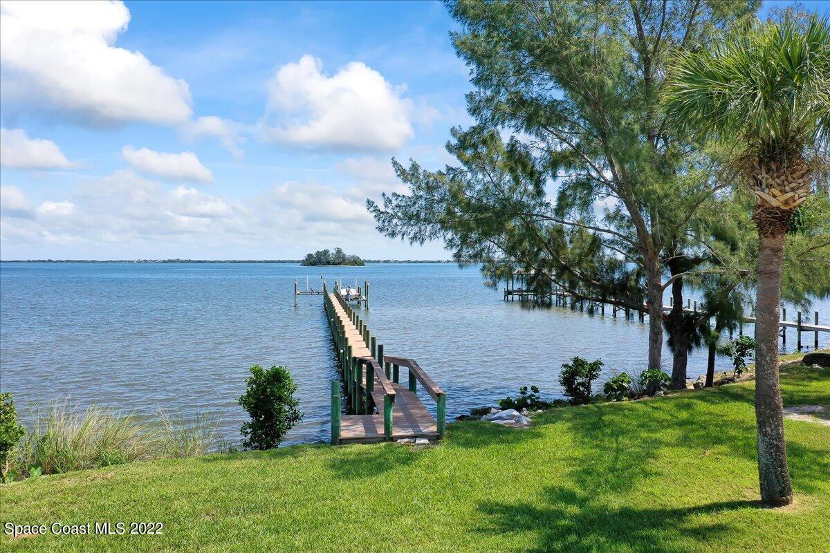 2420 Rocky Point Road Malabar, FL 32950 - Photo 17 of 97 a view of a garden with plants and a bench