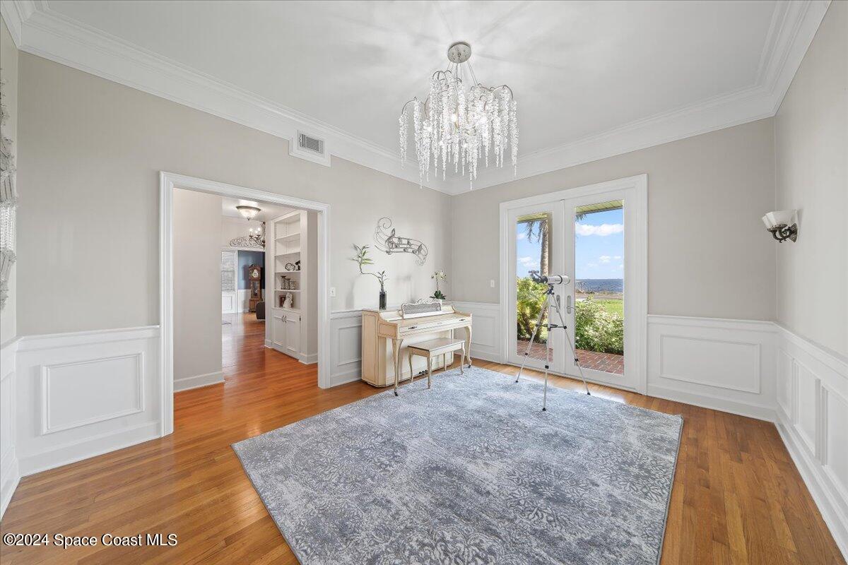 2420 Rocky Point Road Malabar, FL 32950 - Photo 24 of 97 a living room with furniture and a chandelier