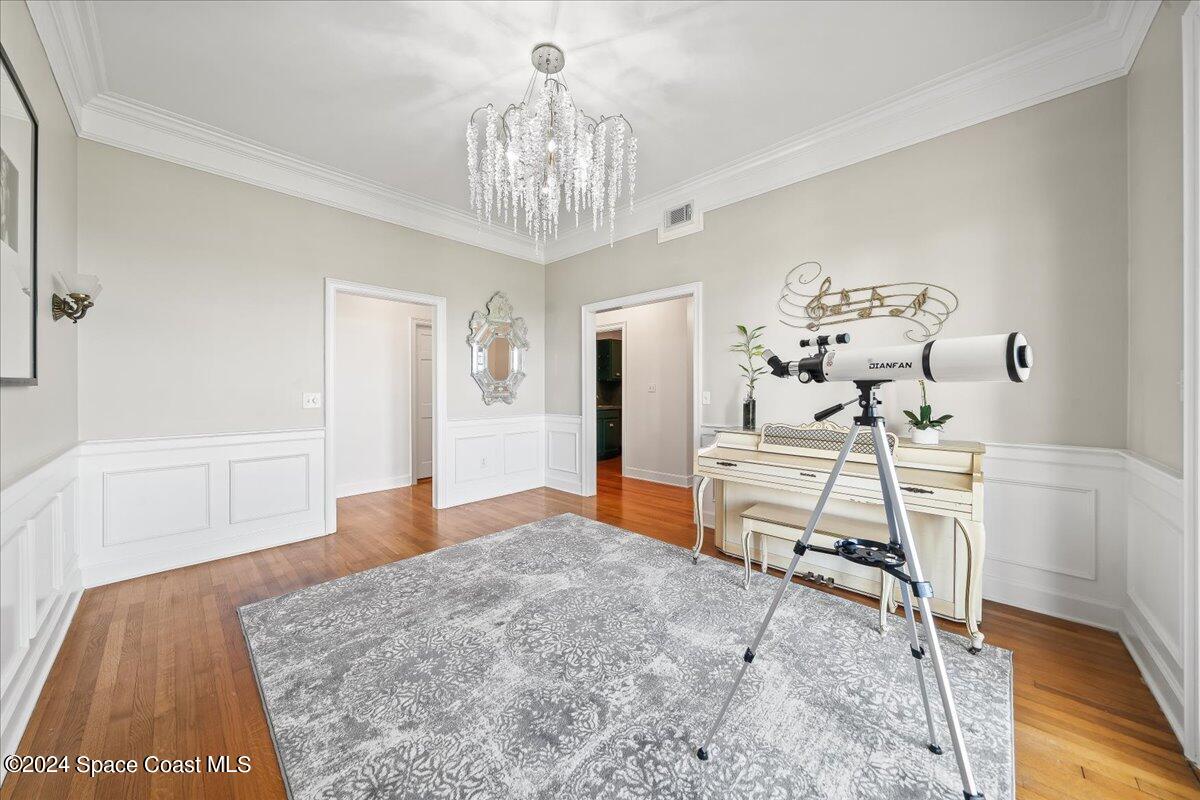 2420 Rocky Point Road Malabar, FL 32950 - Photo 25 of 97 a bedroom with a bed and a chandelier