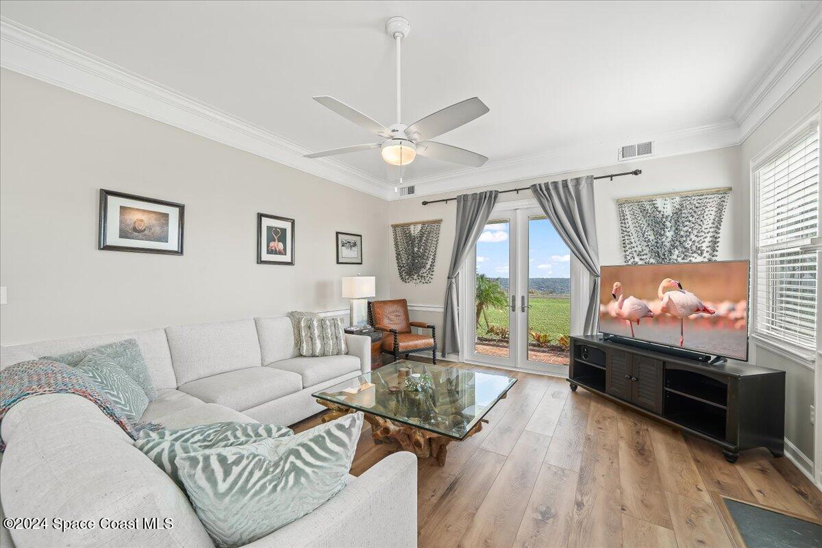 2420 Rocky Point Road Malabar, FL 32950 - Photo 26 of 97 a living room with furniture a flat screen tv and a large window