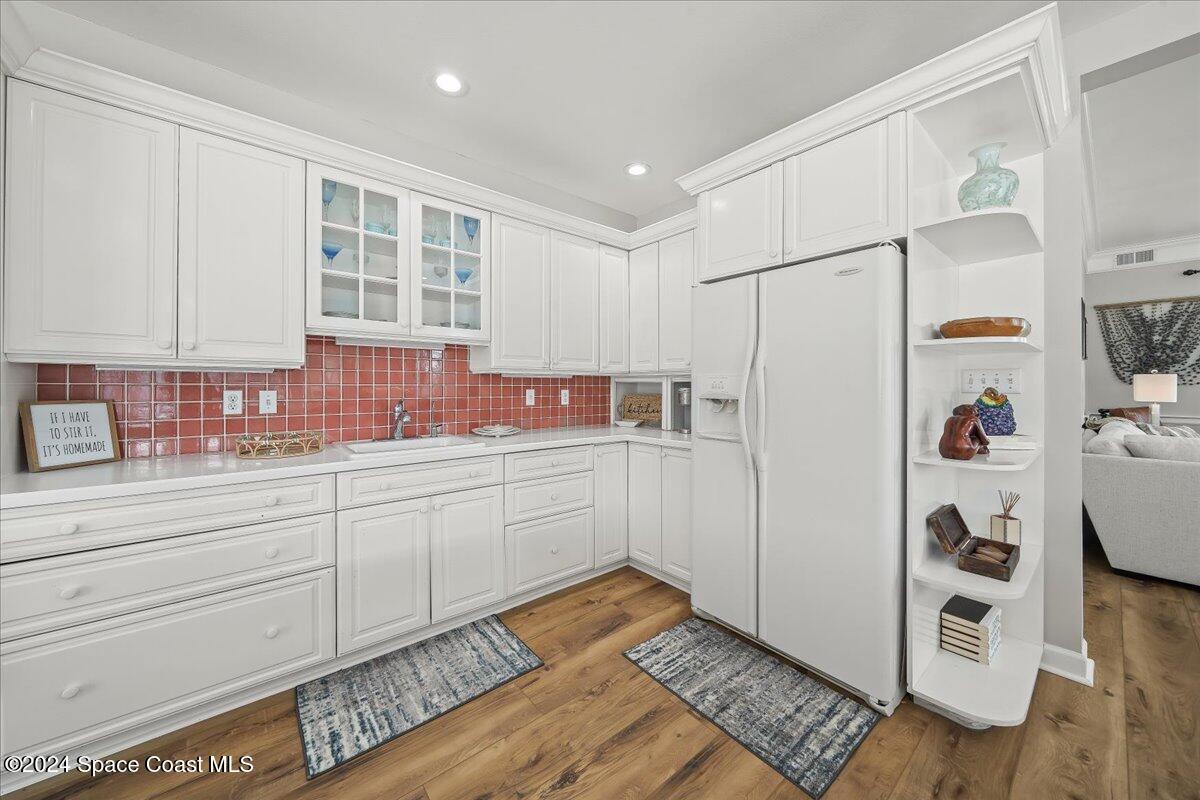 2420 Rocky Point Road Malabar, FL 32950 - Photo 32 of 97 a kitchen with a refrigerator and white cabinets