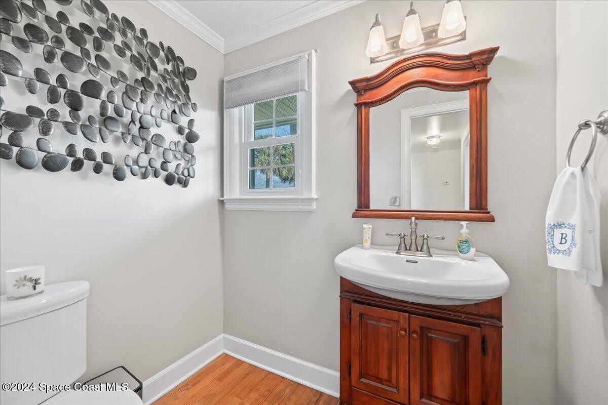 2420 Rocky Point Road Malabar, FL 32950 - Photo 38 of 97 a bathroom with a sink a mirror and a toilet