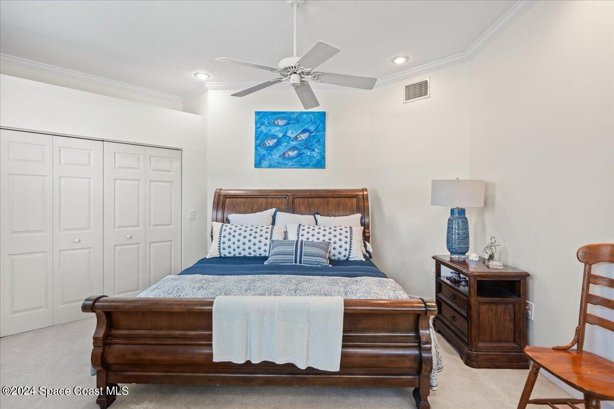 2420 Rocky Point Road Malabar, FL 32950 - Photo 39 of 97 a bedroom with a bed and a table in it