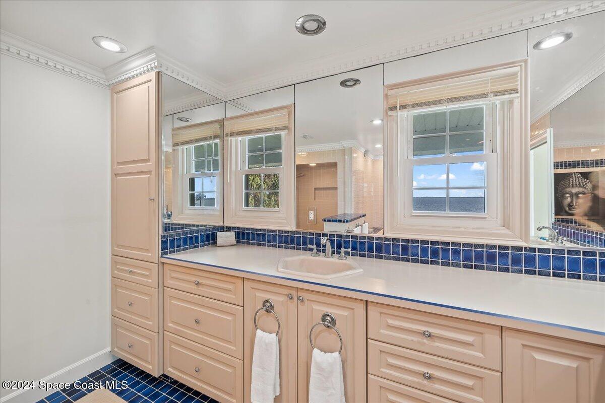 2420 Rocky Point Road Malabar, FL 32950 - Photo 48 of 97 a bathroom with a sink and a mirror