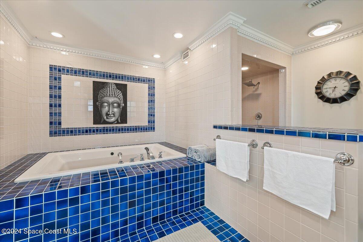 2420 Rocky Point Road Malabar, FL 32950 - Photo 49 of 97 a bathroom with a bathtub and a shower