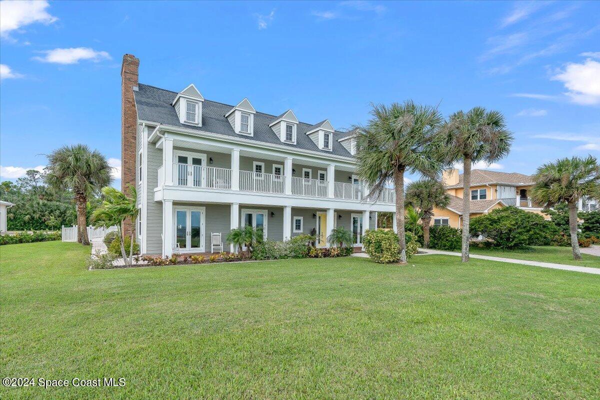 2420 Rocky Point Road Malabar, FL 32950 - Photo 5 of 97 a front view of a building with a garden