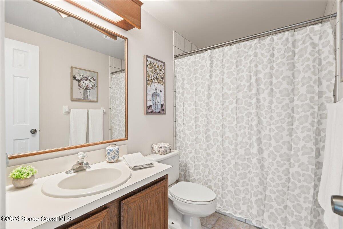 2420 Rocky Point Road Malabar, FL 32950 - Photo 60 of 97 a bathroom with a granite countertop sink and a mirror