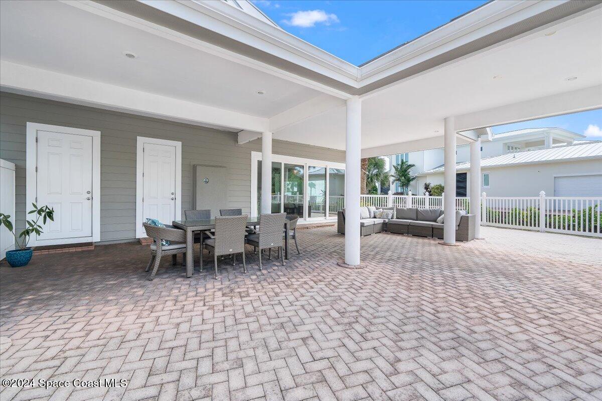 2420 Rocky Point Road Malabar, FL 32950 - Photo 74 of 97 a living room with furniture a dining table and a potted plant