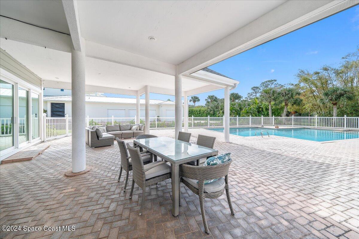 2420 Rocky Point Road Malabar, FL 32950 - Photo 75 of 97 a view of a patio with a table chairs and backyard