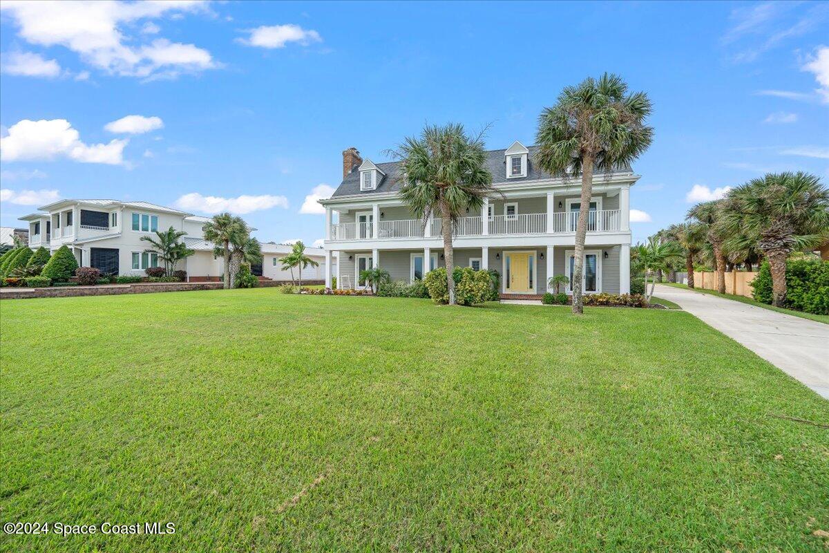 2420 Rocky Point Road Malabar, FL 32950 - Photo 79 of 97 a view of a house with a big yard and large trees