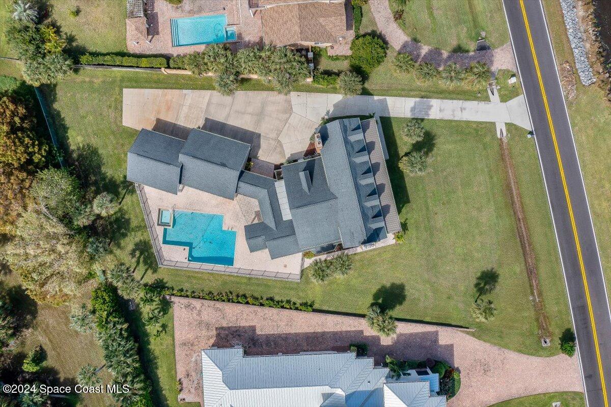 2420 Rocky Point Road Malabar, FL 32950 - Photo 91 of 97 an aerial view of a house with a garden and swimming pool