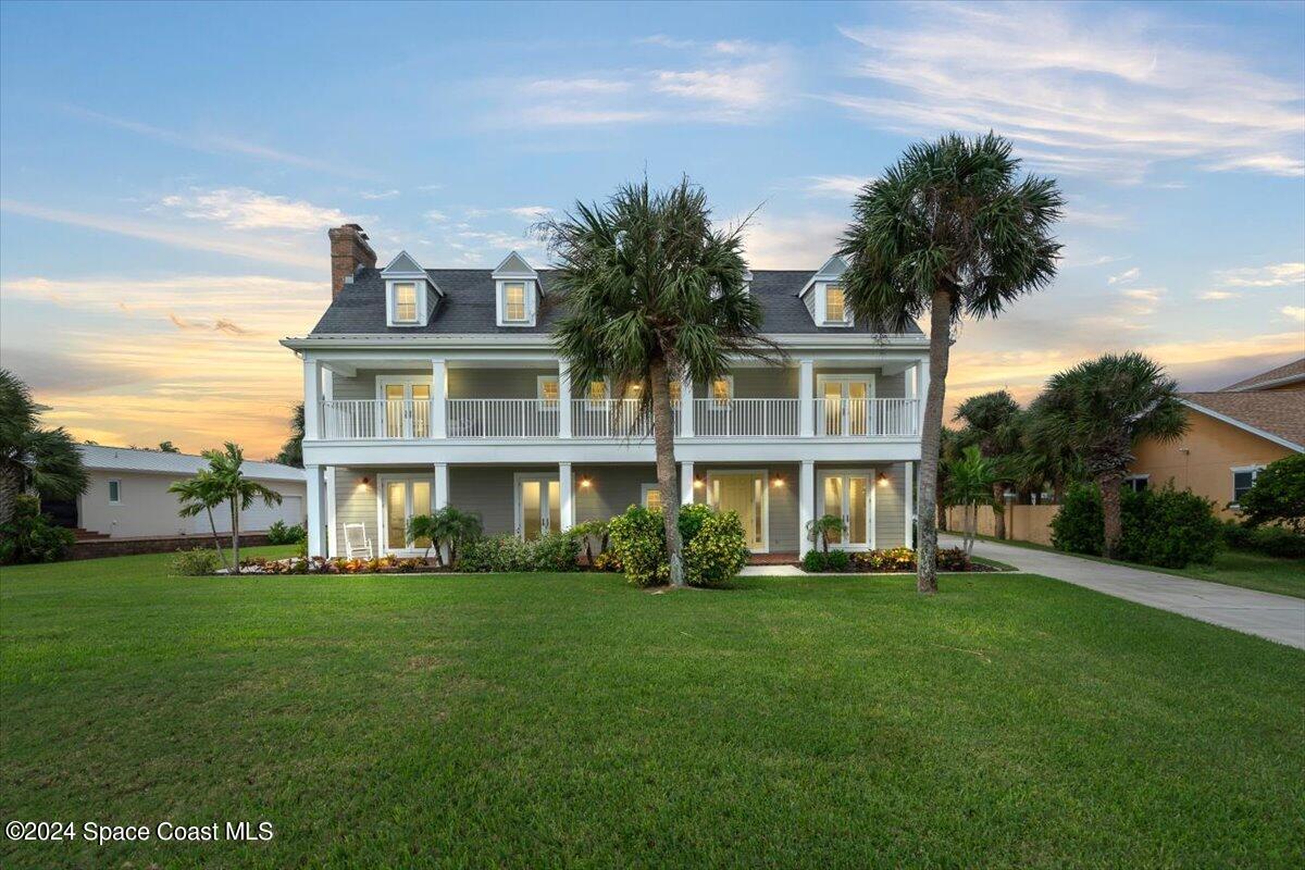 2420 Rocky Point Road Malabar, FL 32950 - Photo 93 of 97 a front view of a house with a garden