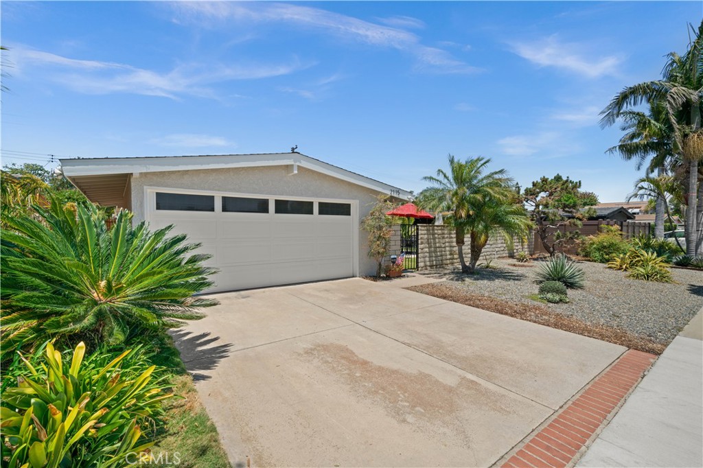 a front view of a house with a yard and a garage