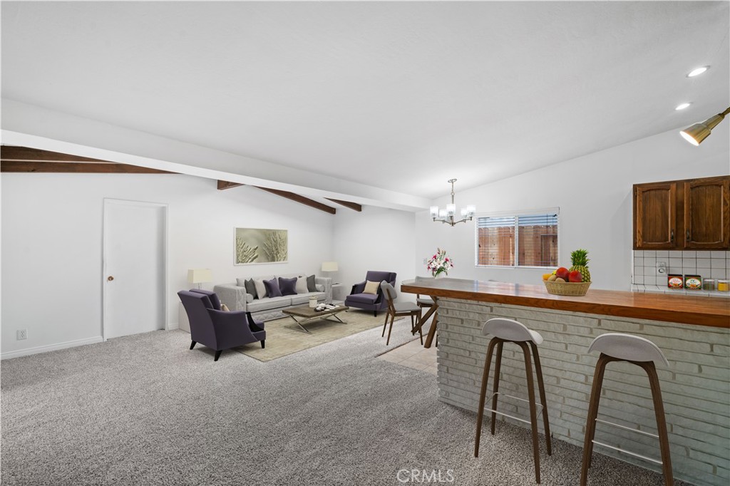2115 Sterling Avenue Costa Mesa, CA 92627 - Photo 14 of 53 a living room with furniture a flat screen tv and kitchen view
