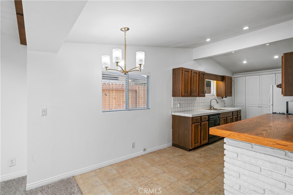 2115 Sterling Avenue Costa Mesa, CA 92627 - Photo 22 of 53 a kitchen with stainless steel appliances granite countertop a sink and a stove