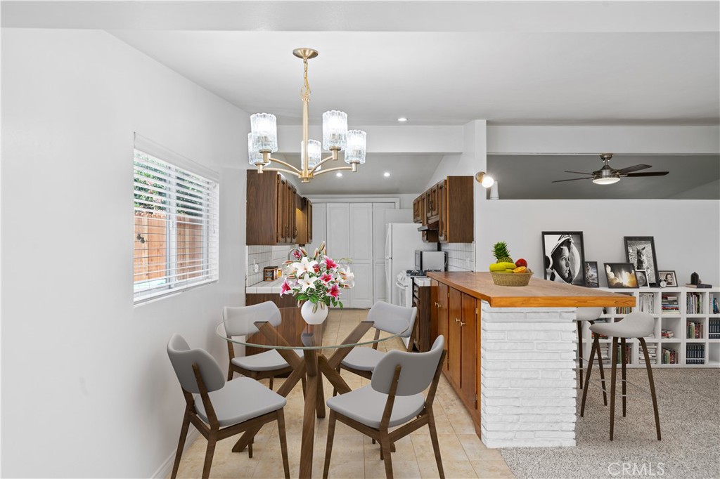 2115 Sterling Avenue Costa Mesa, CA 92627 - Photo 25 of 53 a dining room with furniture and chandelier