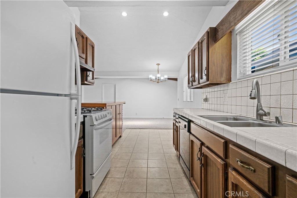 2115 Sterling Avenue Costa Mesa, CA 92627 - Photo 31 of 53 a kitchen with stainless steel appliances granite countertop a sink and cabinets