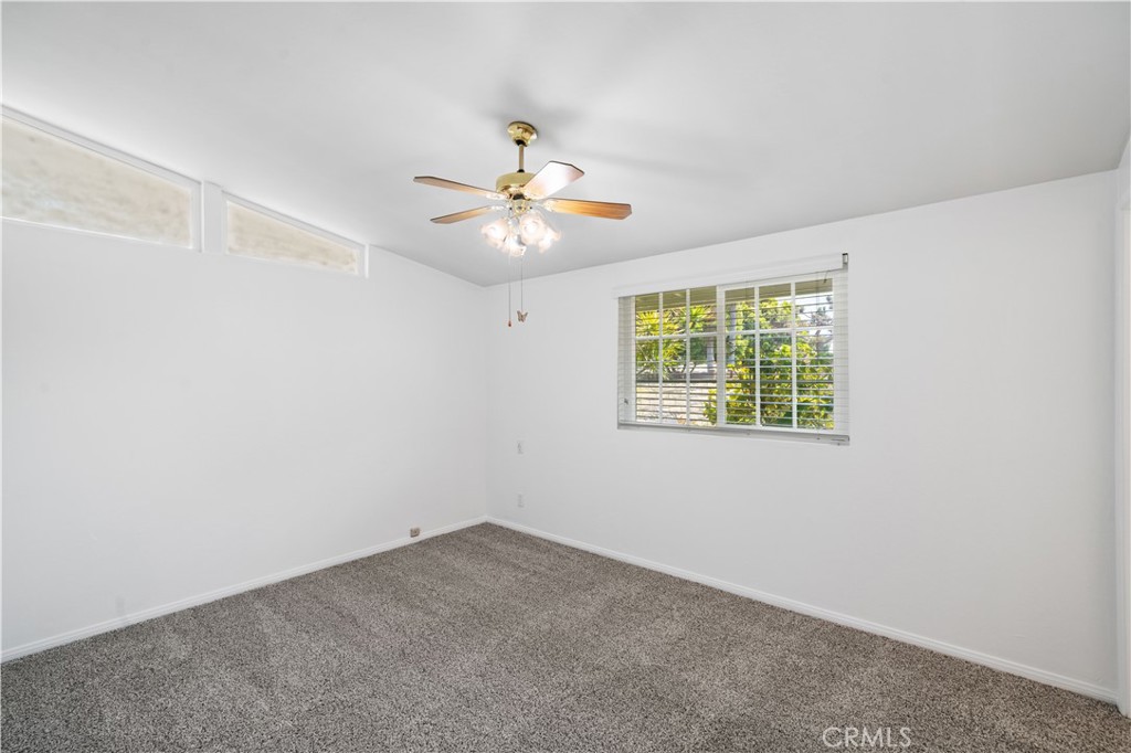 2115 Sterling Avenue Costa Mesa, CA 92627 - Photo 42 of 53 an empty room with windows and fan
