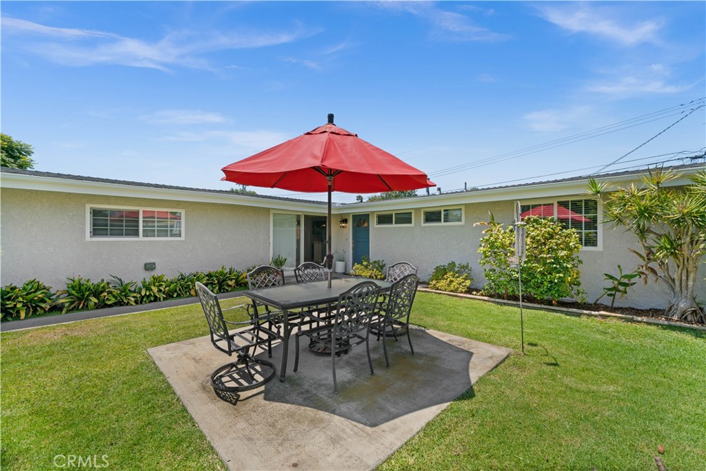 2115 Sterling Avenue Costa Mesa, CA 92627 - Photo 6 of 53 a patio with a table and chairs under an umbrella
