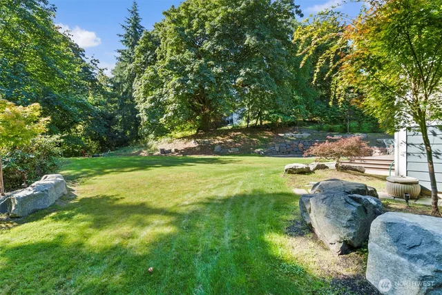 a backyard of a house with table and chairs