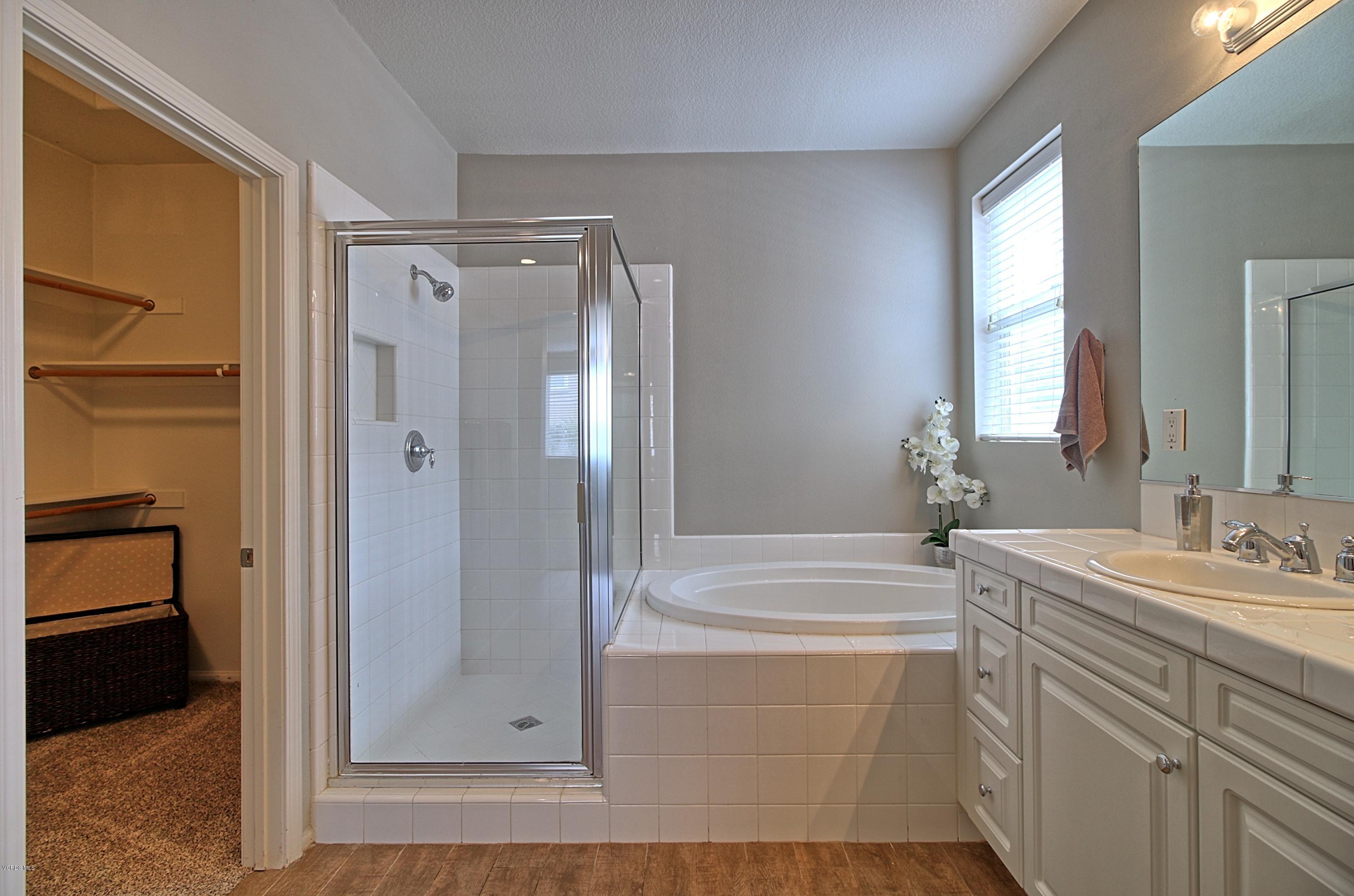 3305 Dunkirk Drive Oxnard, CA 93035 - Photo 13 of 20 a bathroom with a tub sink shower and mirror
